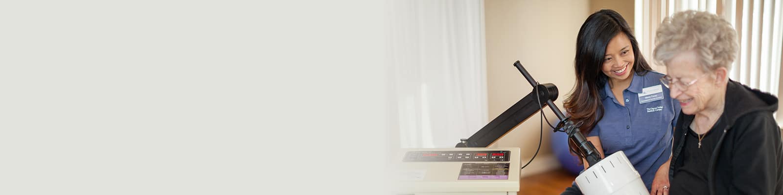 A Pine Creek rehab therapist with an elderly woman in the rehab gym