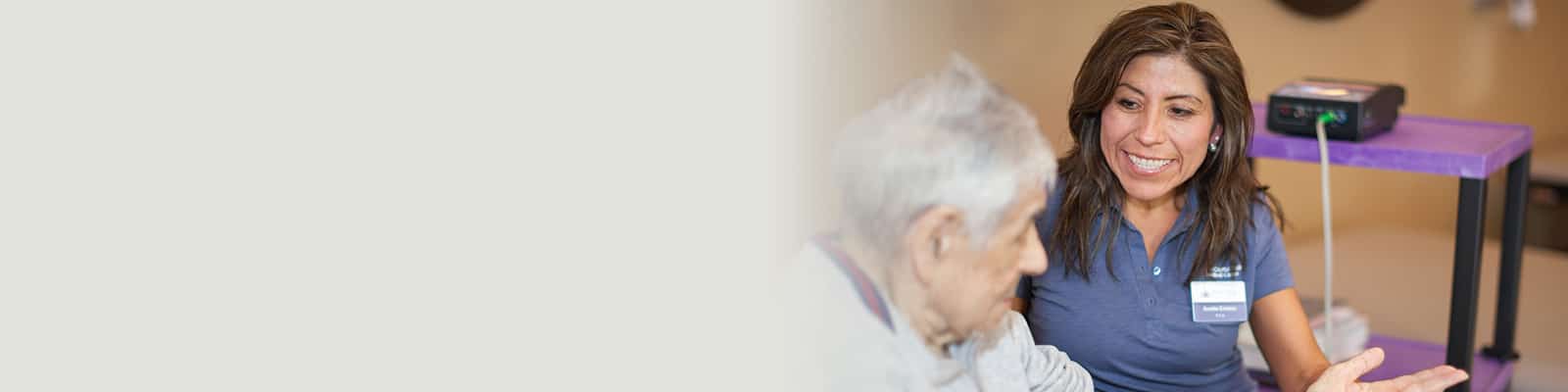 a nurse with an elderly woman providing caregiving services at Pine Creek